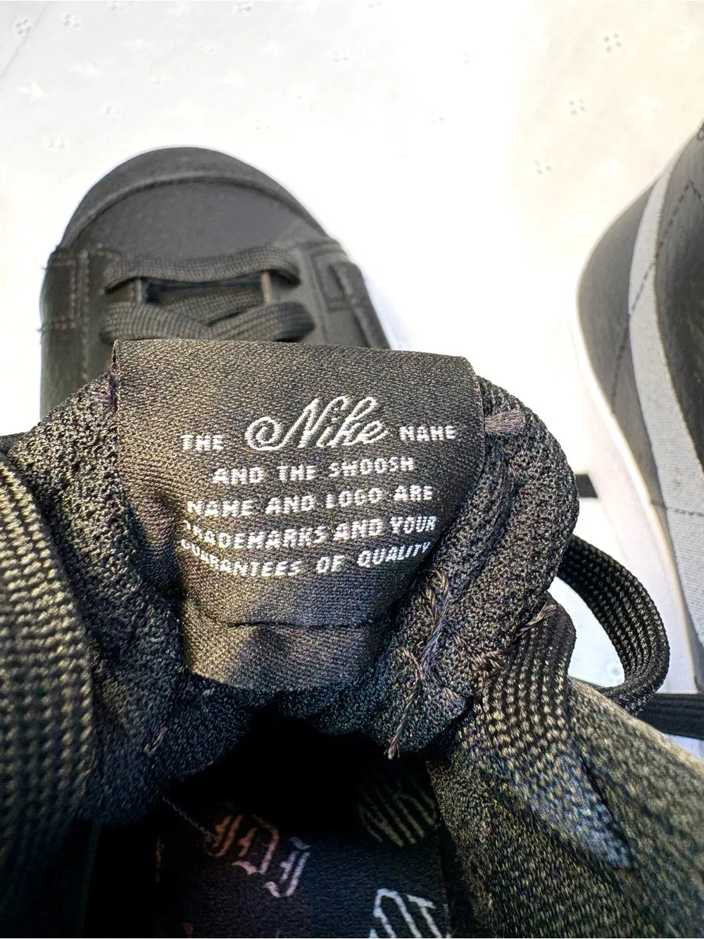 Nike Black High-Top Sneakers with White Tongue Text
